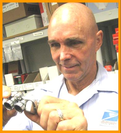 Man examining miniature binoculars