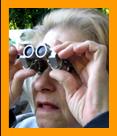 Old Woman looking through miniature  Binoculars.
Woman using biinoculars.
Woman with binoculars.
Femme utilisant de jumelles.
Frau schaut durch ein miniatur fernglas.
Femme regardant a travers de jumelles miniature.
Mujer mirando a traves de binoculares en miniatura prismatoicos.
Donna che guarda attaraverso il binocolo in miniatura.
Donna che usa il binocolo.
Vrouw met verrekijker.
Kvinne som bruker kikkert.
Kobieta za pomoca lotnetki.
Muz pouzvajici dalekohled.
Kvinde de burger en kikkert.
No hasznal tavcsovet.
Nainen kayttaa kiikareita.
Mulher usando binoculos.
Sieviete kas izmanto binokli.
Moteris bessinaodojanti ziuronais. 
6x15 binoculars.
7x18 binoculars.
